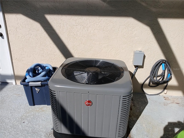 exterior details featuring stucco siding and central air condition unit