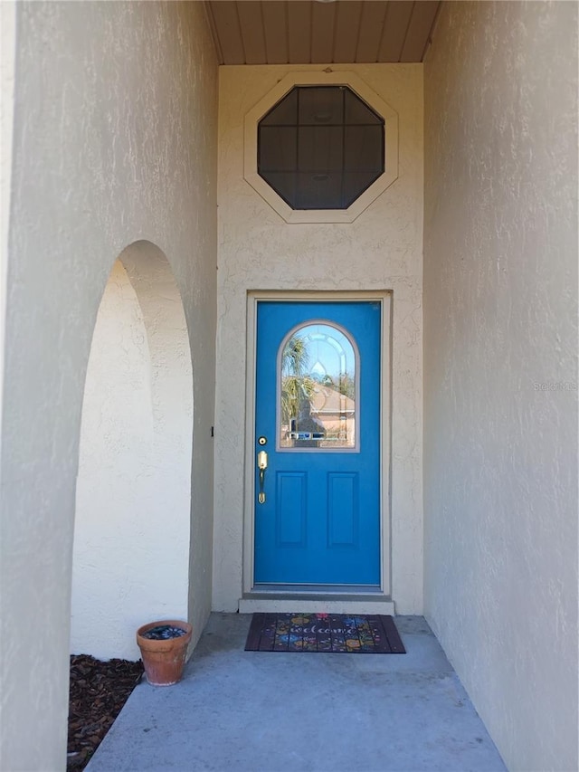 doorway to property with stucco siding