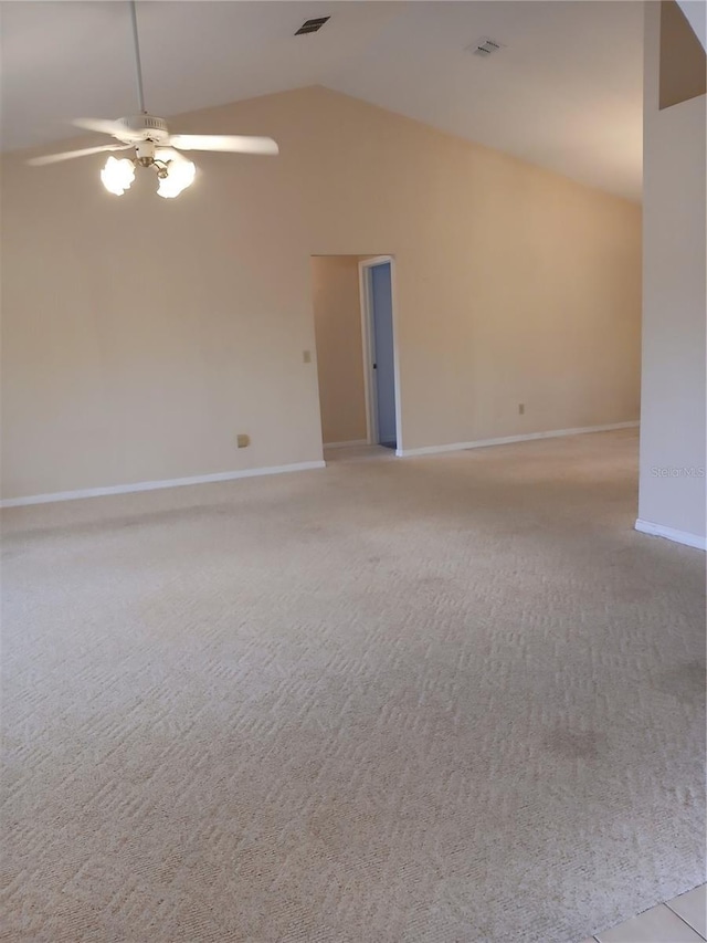 unfurnished room featuring visible vents, light carpet, ceiling fan, high vaulted ceiling, and baseboards