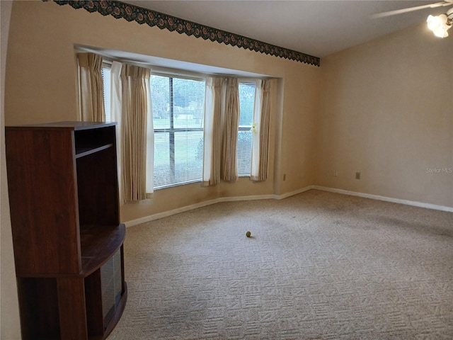 interior space featuring ceiling fan and baseboards