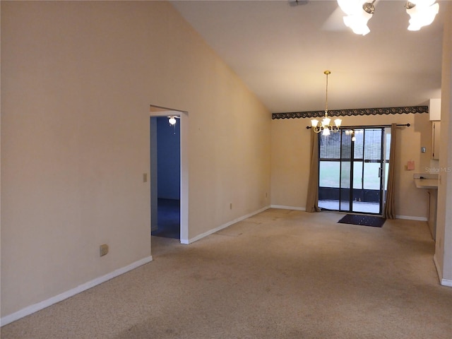 spare room featuring high vaulted ceiling, baseboards, a notable chandelier, and light colored carpet