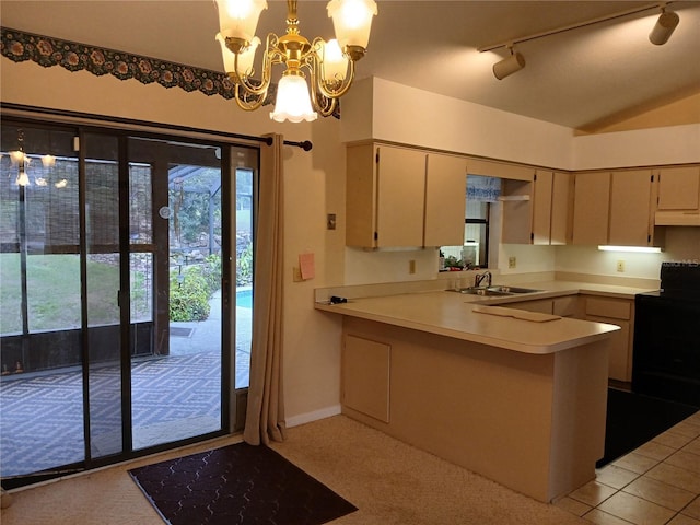 kitchen with black / electric stove, a peninsula, a sink, light countertops, and decorative light fixtures