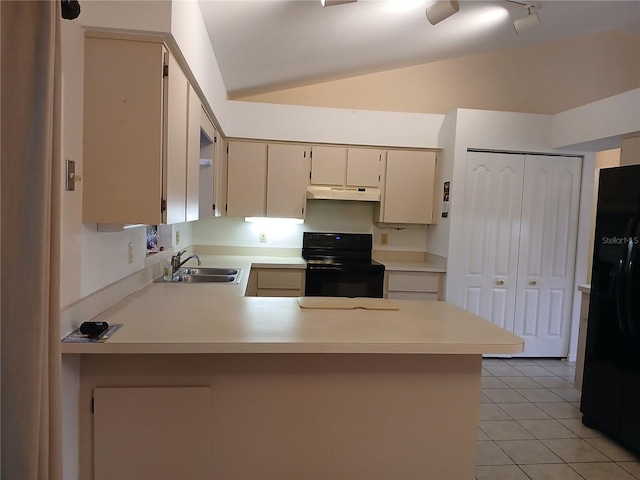 kitchen with cream cabinetry, light countertops, a peninsula, under cabinet range hood, and black appliances