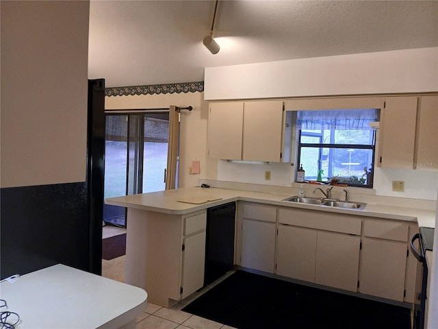 kitchen with light tile patterned floors, light countertops, a sink, dishwasher, and a peninsula