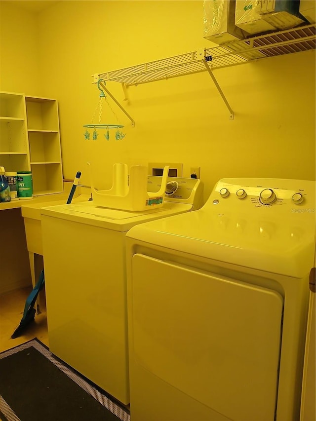 washroom featuring washing machine and dryer and laundry area