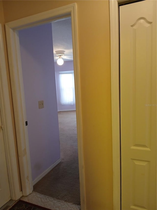 hall with carpet and baseboards