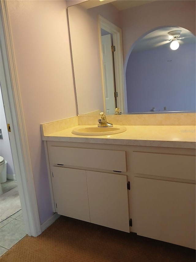 bathroom with a ceiling fan, tile patterned flooring, vanity, and toilet