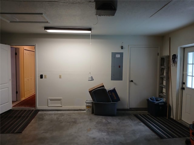 garage with electric panel and a garage door opener