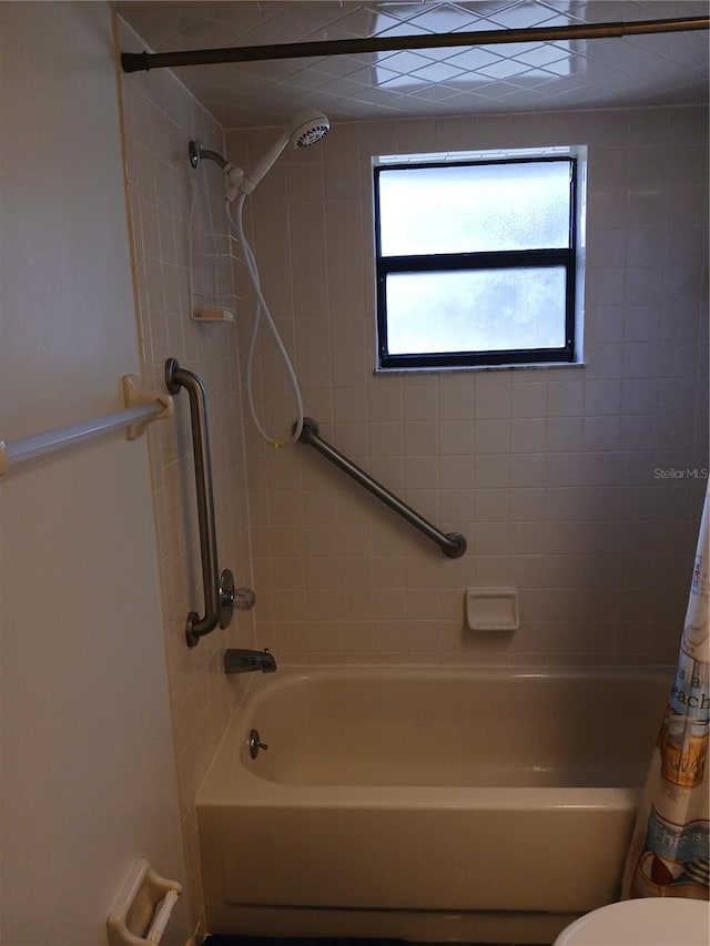 bathroom with toilet and shower / bathtub combination with curtain