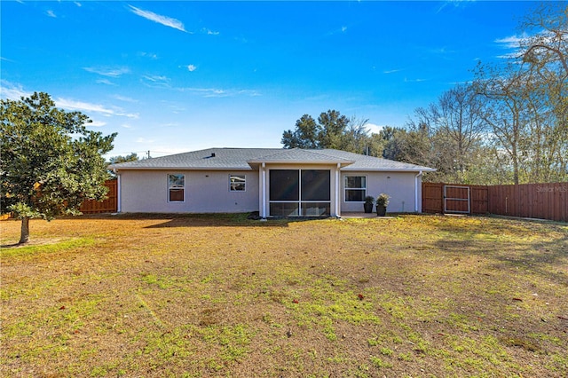 back of property featuring a lawn