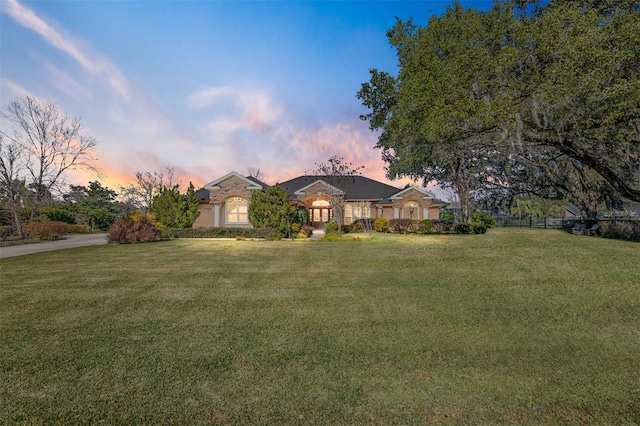 ranch-style house featuring a yard