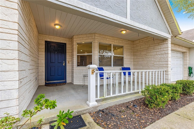 property entrance with a porch and a garage