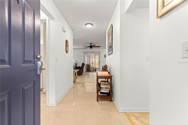 interior space with light tile patterned flooring and a textured ceiling