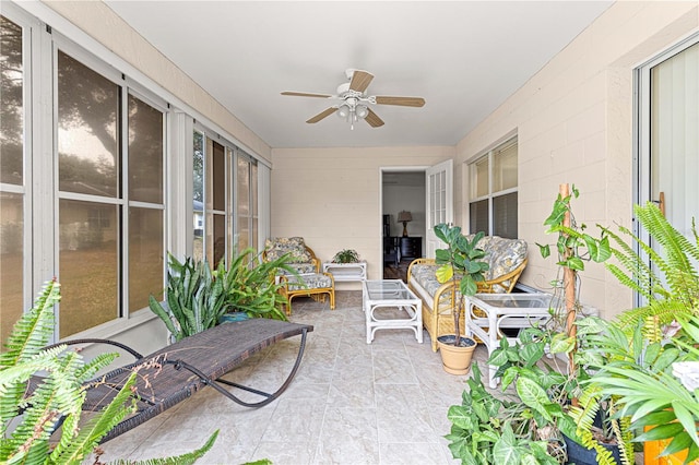 sunroom featuring ceiling fan