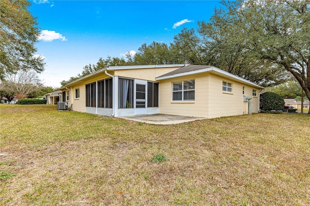 back of property featuring cooling unit, a yard, a sunroom, and a patio