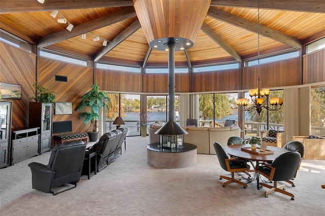 sunroom featuring wood ceiling, a chandelier, and vaulted ceiling with beams