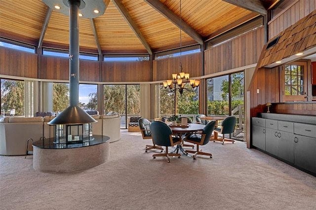 sunroom featuring wooden ceiling, a wealth of natural light, lofted ceiling with beams, and a notable chandelier