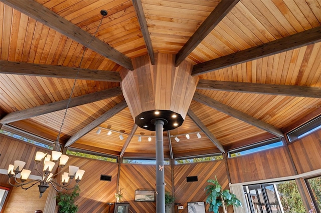 details with an inviting chandelier and beam ceiling