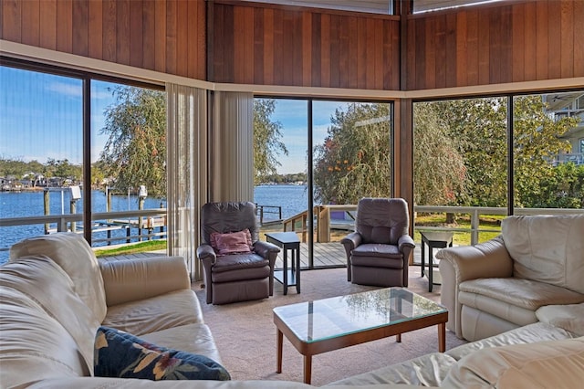 sunroom / solarium featuring a water view