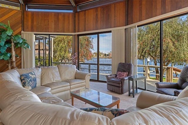 sunroom featuring a water view