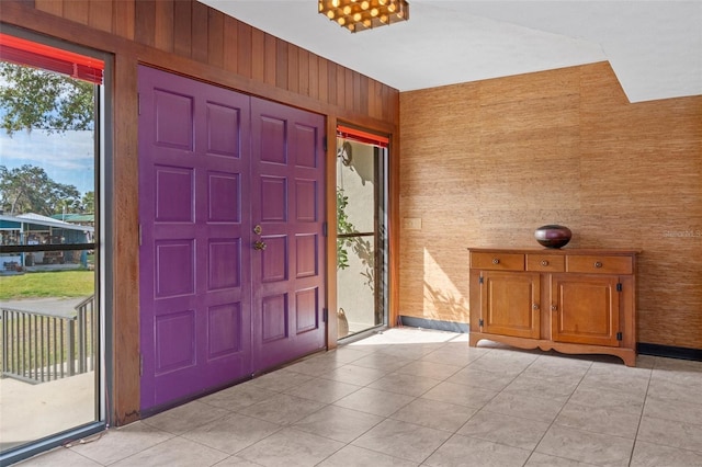 foyer with wood walls