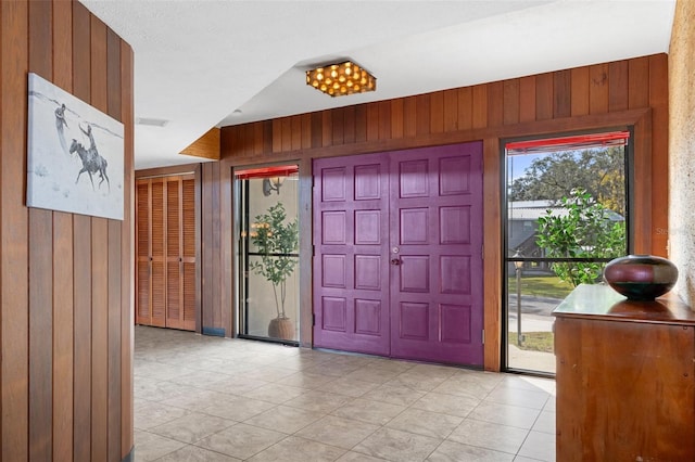 entrance foyer featuring wood walls