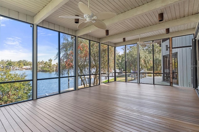 unfurnished sunroom with beamed ceiling, a water view, and ceiling fan