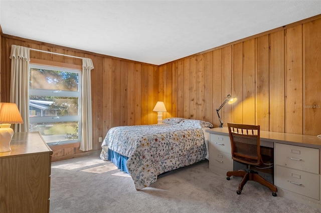 bedroom with multiple windows, light carpet, and wood walls