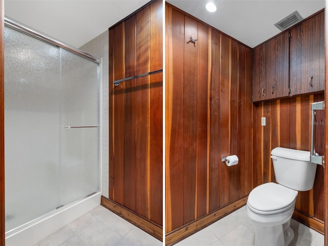 bathroom with walk in shower, tile patterned floors, and toilet