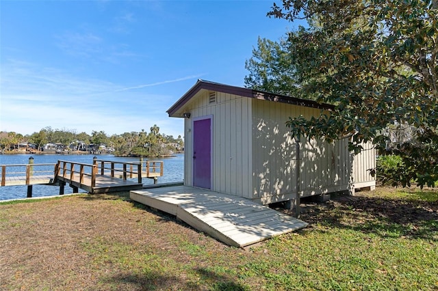 dock area featuring a lawn and a water view