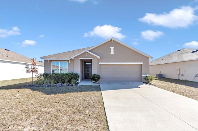 ranch-style house featuring central AC unit, a garage, and a front yard