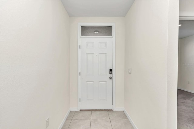 doorway with light tile patterned floors