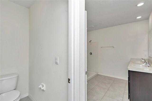 bathroom with vanity, tile patterned floors, and toilet