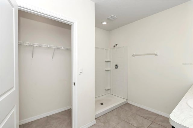 bathroom featuring a shower, tile patterned floors, and vanity