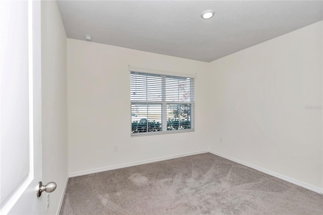 spare room with light colored carpet