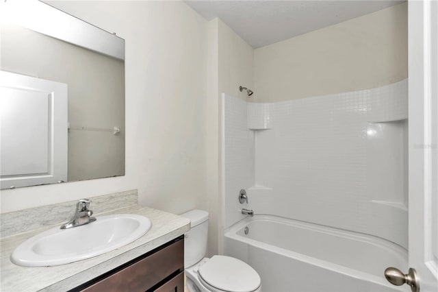 full bathroom featuring washtub / shower combination, vanity, and toilet