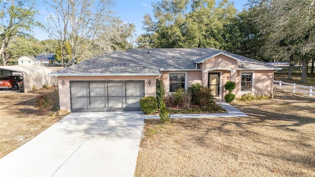 single story home featuring a garage, a front lawn, and a carport