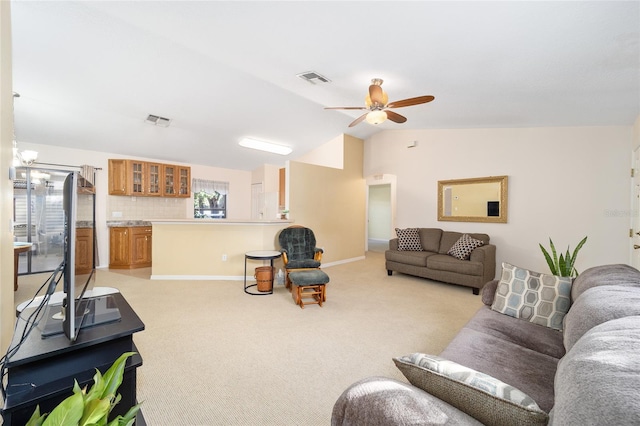 living room featuring lofted ceiling, light carpet, and ceiling fan