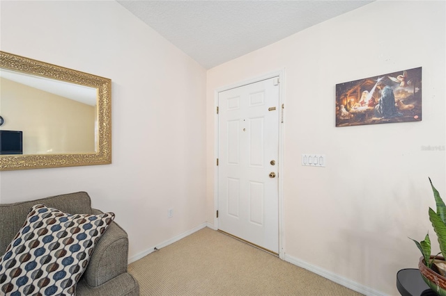 entrance foyer featuring lofted ceiling and light carpet