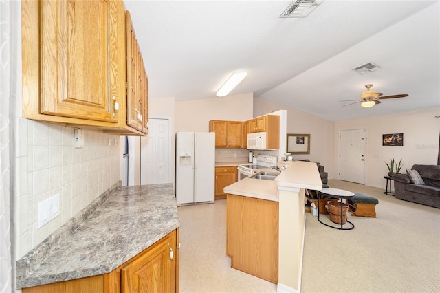 kitchen with lofted ceiling, decorative backsplash, ceiling fan, kitchen peninsula, and white appliances