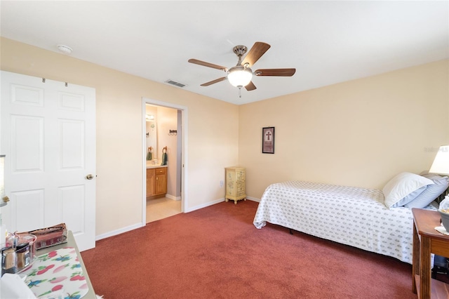 bedroom featuring ensuite bath, ceiling fan, and carpet flooring