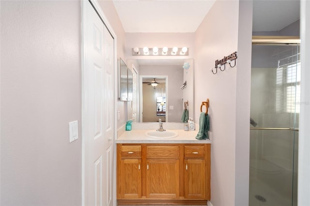 bathroom featuring vanity and a shower with shower door