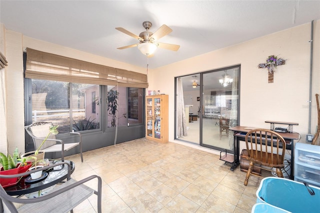 interior space with ceiling fan