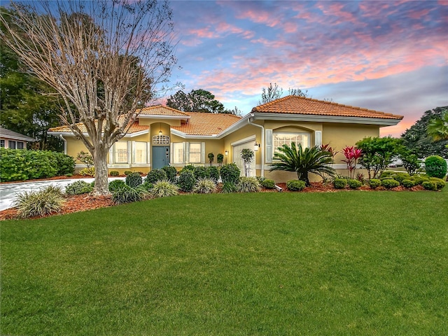 mediterranean / spanish home with a lawn