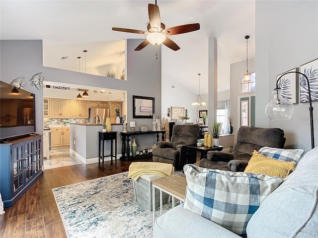 living room with ceiling fan, high vaulted ceiling, and dark hardwood / wood-style flooring