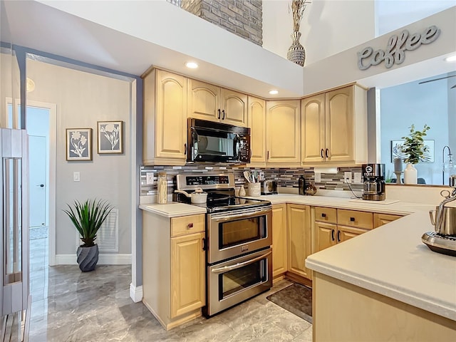 kitchen featuring double oven range, backsplash, and light brown cabinetry