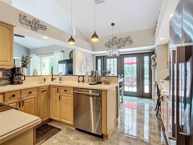 kitchen featuring vaulted ceiling, dishwasher, sink, hanging light fixtures, and light brown cabinets