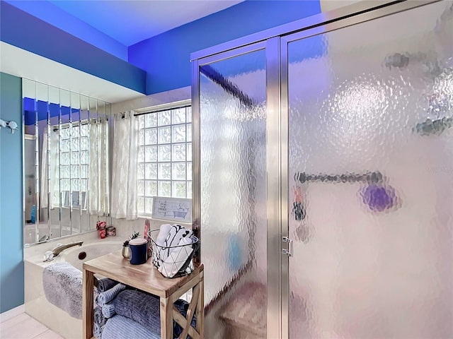 bathroom with tile patterned floors and an enclosed shower