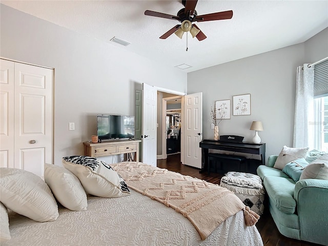 bedroom with dark hardwood / wood-style flooring, a textured ceiling, and ceiling fan