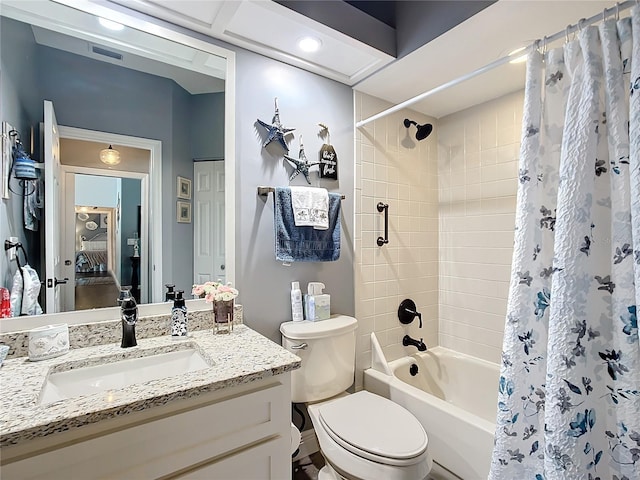 full bathroom featuring shower / bathtub combination with curtain, vanity, and toilet